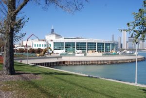 Rear view of the John G. Shedd Aquarium, highlighting its restored masonry and architectural features against the surrounding landscape.