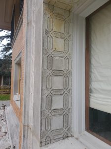 After restoration image of the Winslow House entry, showcasing the revitalized architectural details and enhanced masonry, reflecting Frank Lloyd Wright's design.